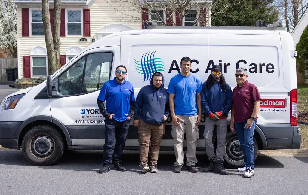 A-C Air Care team standing beside a branded service van